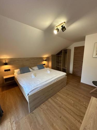 a bedroom with a large white bed in a room at Pension ALPENHAUS in Vorderstoder
