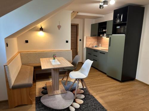 a small kitchen with a table and a dining room at Pension ALPENHAUS in Vorderstoder