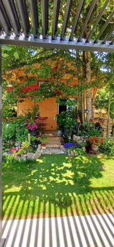 a garden with a pergola and some flowers at Le Jardin D' Épicure in Oderen