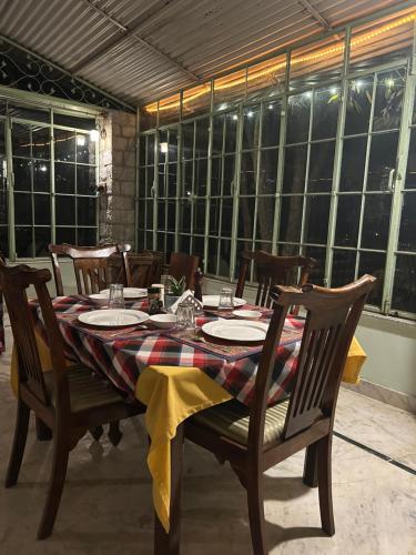 a dining room table with a plaid table cloth at Korta Escape- A Heritage Resort in Jawai in Korta