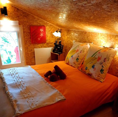a bed with two teddy bears sitting on top of it at Le Jardin D' Épicure in Oderen