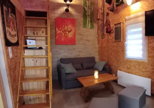 a living room with a couch and a table at Le Jardin D' Épicure in Oderen