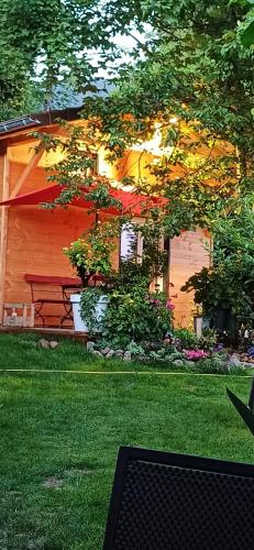 a house with a picnic table in the yard at Le Jardin D' Épicure in Oderen