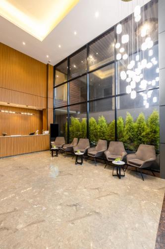 a lobby with couches and chairs in a building at Saltstayz Autograph - Advant & Sector 144 in Noida