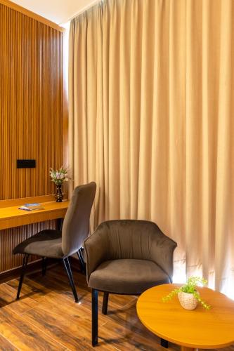 a room with a desk and a chair and a table at Saltstayz Autograph - Advant & Sector 144 in Noida
