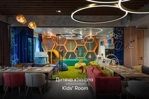 a restaurant with tables and chairs and a stage at Apartel Uzhhorod in Uzhhorod