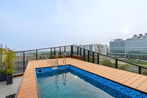 a swimming pool on the roof of a building at Saltstayz Autograph - Advant & Sector 144 in Noida
