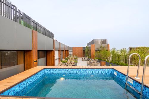 a swimming pool on the roof of a house at Saltstayz Autograph - Advant & Sector 144 in Noida