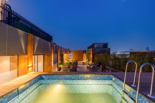 a swimming pool on the roof of a house at Saltstayz Autograph - Advant & Sector 144 in Noida