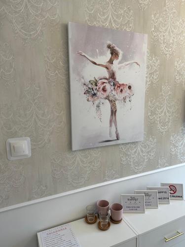 a painting of a ballet dancer on a wall at Happy8 in Gdynia