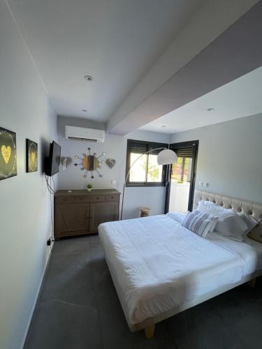 un dormitorio con una cama grande blanca y una ventana en Les Borels, en Marsella