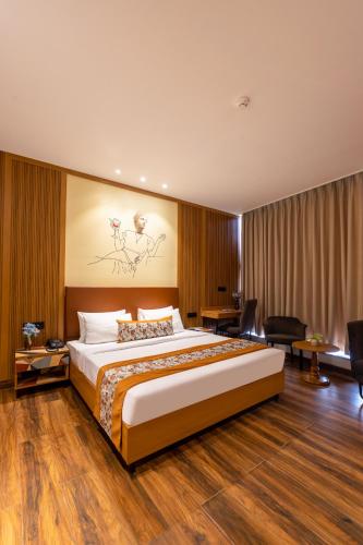 a bedroom with a large bed in a room at Saltstayz Autograph - Advant & Sector 144 in Noida
