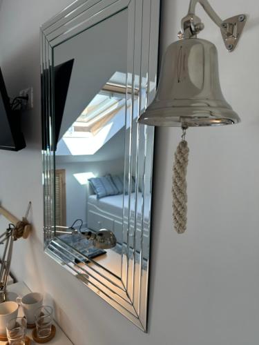 a mirror on a wall next to a bed at Happy8 in Gdynia
