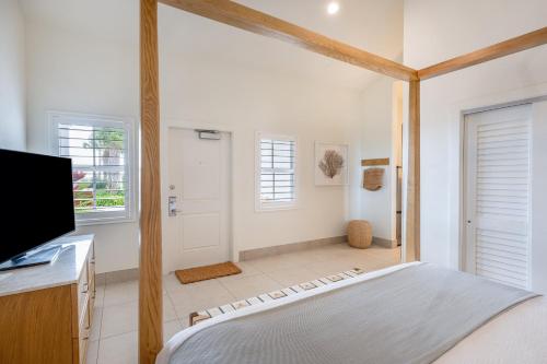 a bedroom with a bed and a flat screen tv at Islander Resort in Islamorada