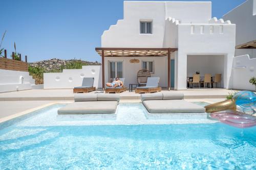 a villa with a swimming pool and a house at Depis private villas Plaka Naxos in Plaka