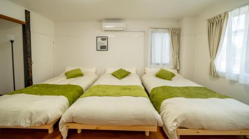 a group of four beds in a room at Casa G,S, - Vacation STAY 53480v in Osaka