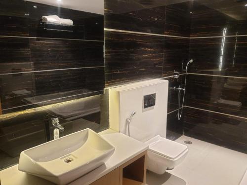 a bathroom with a sink and a toilet at Hotel Shemron 