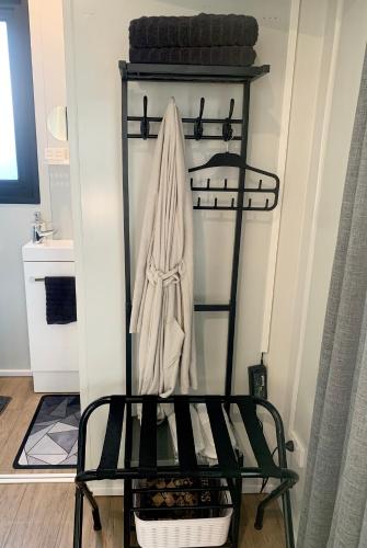 a black shelf with a towel hanging on it at Highway to Hobbiton Guesthouse - Matamata Central Location in Matamata