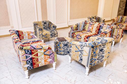 a room with several chairs andupholstered at Shymkent Grand Hotel in Shymkent