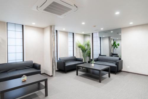 a waiting room with couches and tables and windows at Casa G,S, - Vacation STAY 53485v in Osaka