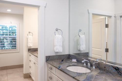 a bathroom with a sink and a large mirror at Islander Resort in Islamorada