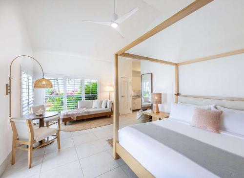 a bedroom with a bed and a desk and a table at Islander Resort in Islamorada