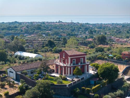 an aerial view of a large red house at Badimà - Villa con piscina in Aci SantʼAntonio