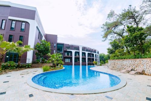 a swimming pool in front of a building at Soc Village Wellness & Retreat in Sóc Sơn