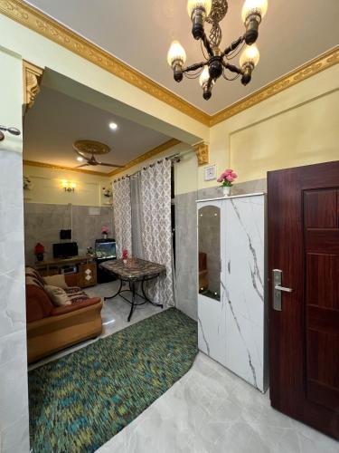 a living room with a door and a couch at Cozy Prime Private Service Apartment in Bangalore in Bengaluru