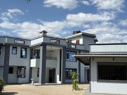 a large white building with a lot of windows at Naivasha Moi Southlake Villas in Naivasha