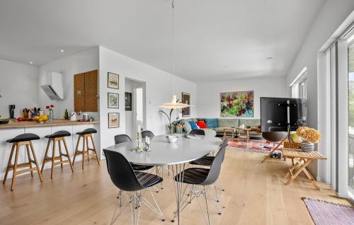 a kitchen and living room with a white table and chairs at Beautiful Home In Fårevejle With Wifi in Fårevejle