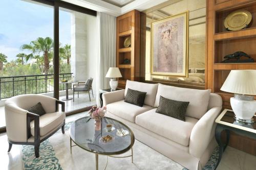 a living room with a white couch and a glass table at The Ritz-Carlton Rabat, Dar Es Salam in Rabat