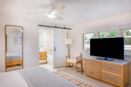 a bedroom with a flat screen tv on a dresser at Islander Resort in Islamorada