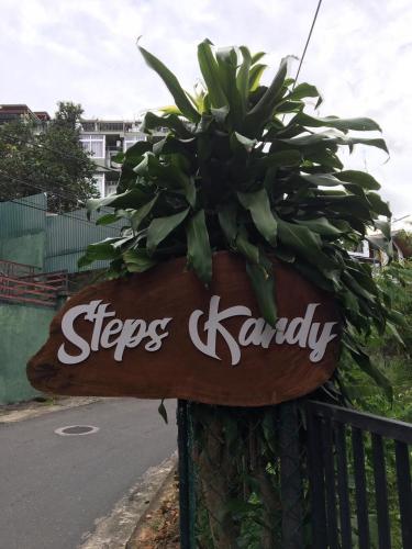 a sign that says steps kandy next to a street at Steps Kandy in Kandy