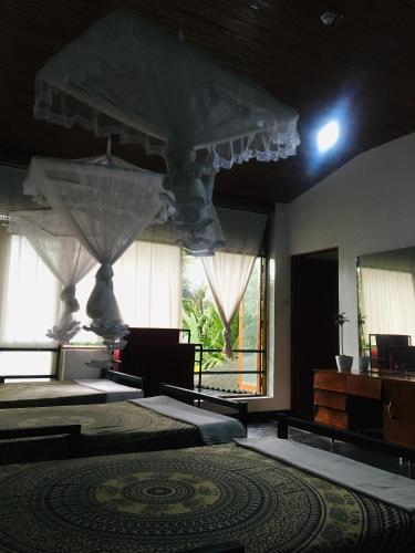 a room with two beds and a large window at Steps Kandy in Kandy