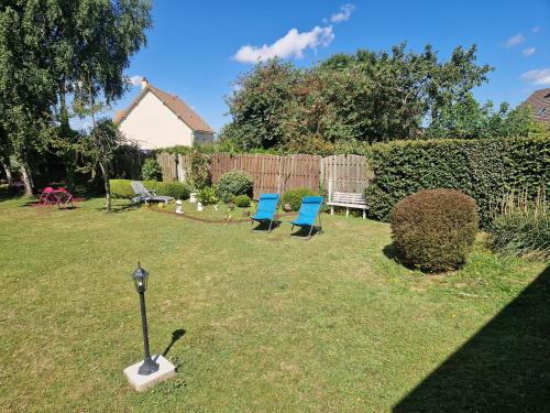 two blue chairs and a lamp in a yard at Leira in Saint-Aubin-dʼArquenay