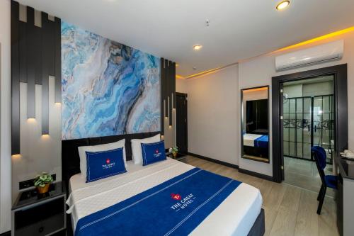 a hotel room with a bed and a painting on the wall at The Great Airport Hotel in Arnavutköy