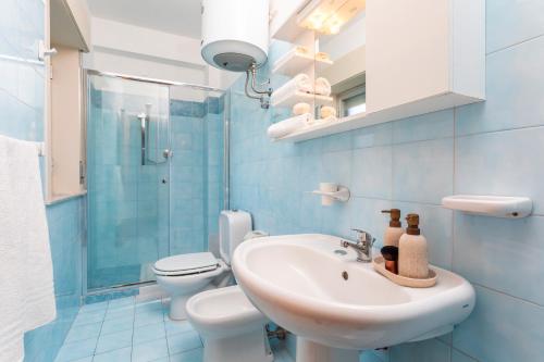 a bathroom with a sink and a toilet at I Ciottoli Dello Ionio in Mascali