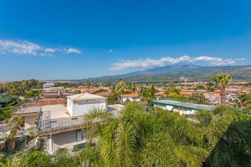 an aerial view of a city with palm trees at I Ciottoli Dello Ionio in Mascali