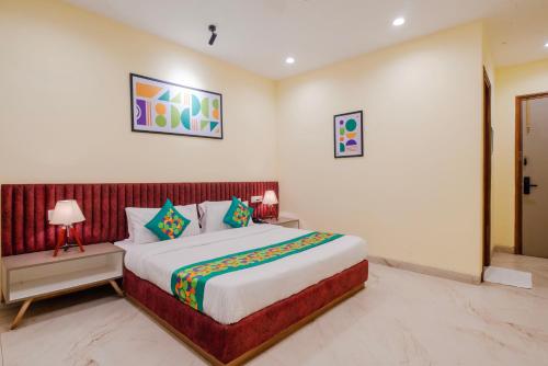 a bedroom with a large bed in a room at Treebo The Mountain Deer Valley Near PGI in Chandīgarh