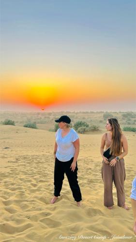 two women standing in the sand on the beach at Amazing Desert Camp in Jaisalmer