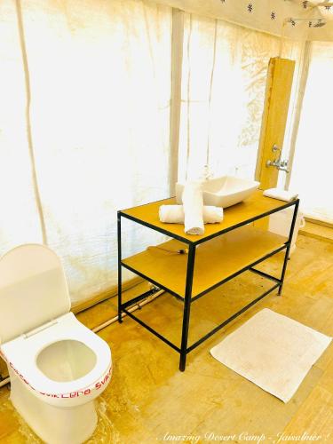 a bathroom with a sink and a toilet at Amazing Desert Camp in Jaisalmer