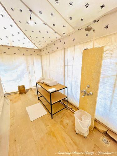 a room with a shower and a toilet in it at Amazing Desert Camp in Jaisalmer