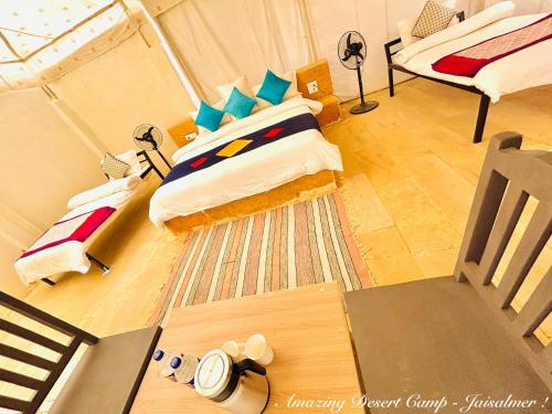 a view of a bedroom with a bed and a couch at Amazing Desert Camp in Jaisalmer