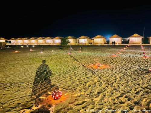 a shadow of a person on a beach at night at Amazing Desert Camp in Jaisalmer