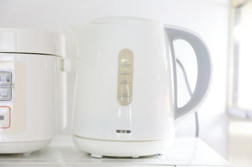 two white appliances sitting on a kitchen counter at シティラデファンス - 2025年6月室内リニューアル in Sapporo