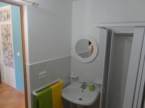 a bathroom with a sink and a mirror at Baciati Dal Sole in Porto Empedocle