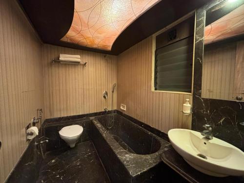un baño con lavabo e inodoro en Hotel Sahar Garden Near Mumbai International Airport, en Bombay