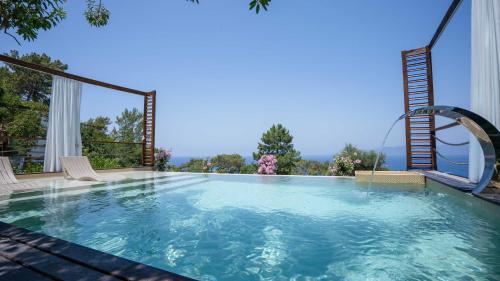 a swimming pool with a view of the mountains at Lov Faralya Adults Only in Faralya