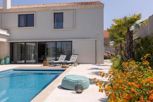 a villa with a swimming pool and a house at Villa Amorosa in Nerezine